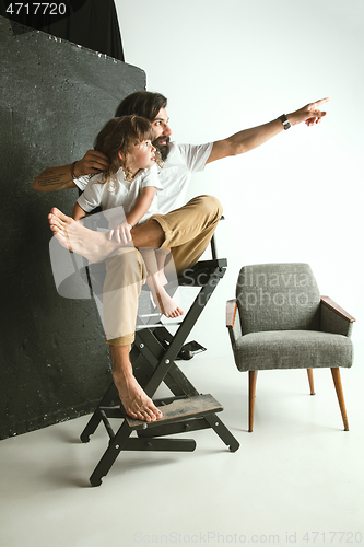 Image of Father playing with young son in their sitting room