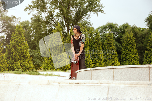 Image of Skateboarder at the city\'s street in cloudly day