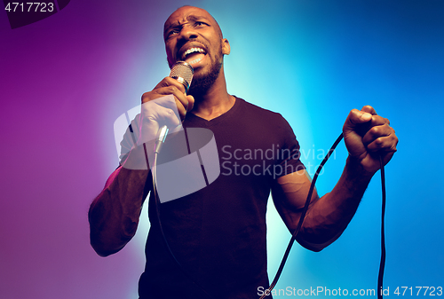 Image of Young african-american jazz musician singing a song