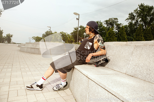 Image of Skateboarder at the city\'s street in cloudly day