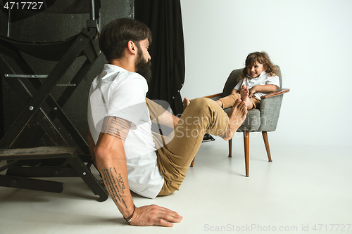 Image of Father playing with young son in their sitting room