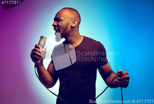 Image of Young african-american jazz musician singing a song