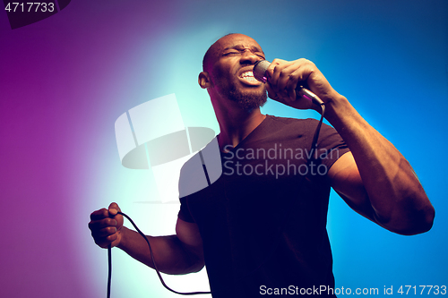 Image of Young african-american jazz musician singing a song