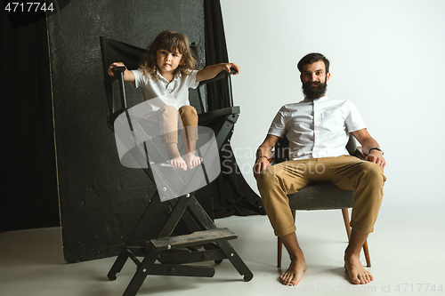 Image of Father playing with young son in their sitting room