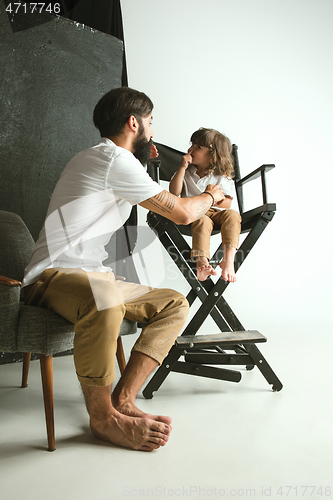 Image of Father playing with young son in their sitting room