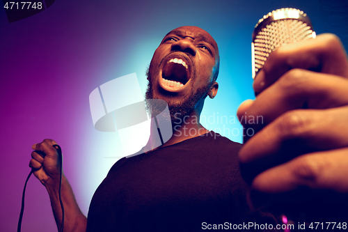 Image of Young african-american jazz musician singing a song