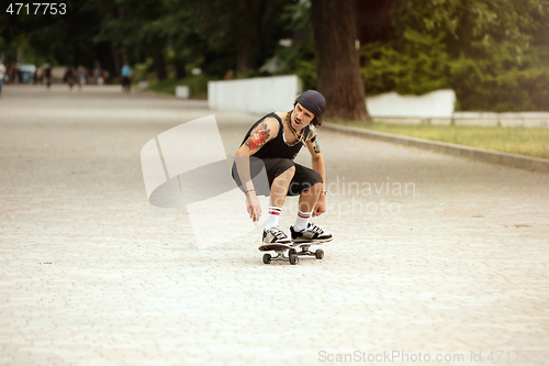 Image of Skateboarder doing a trick at the city\'s street in cloudly day