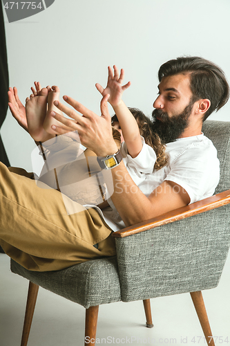 Image of Father playing with young son in their sitting room