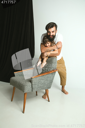 Image of Father playing with young son in their sitting room