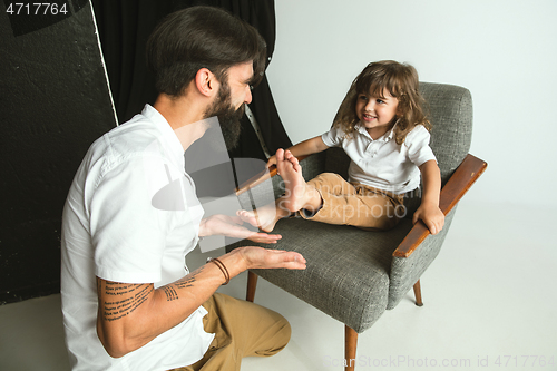 Image of Father playing with young son in their sitting room