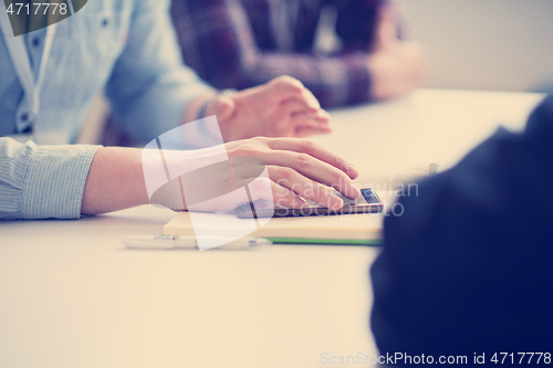 Image of Young casual businessman using smartphone