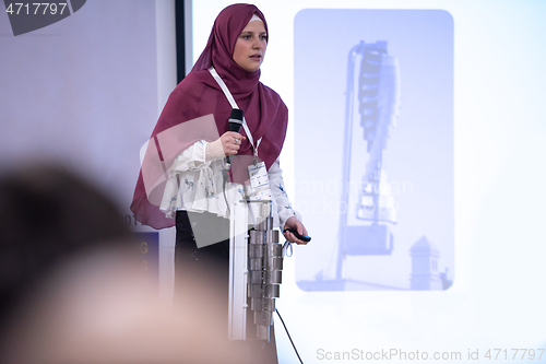 Image of Muslim businesswoman giving presentations at conference room