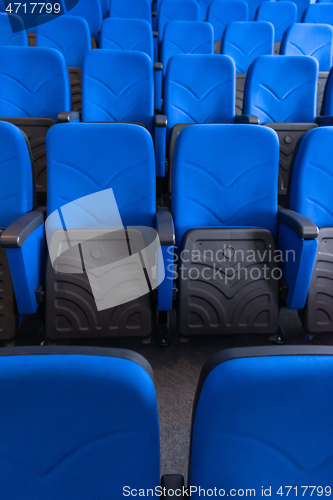 Image of hall with rows of blue seats