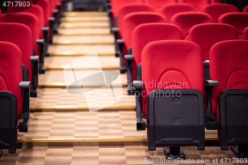 Image of hall with rows of red seats