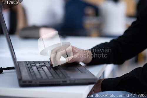 Image of business people hands using laptop computer