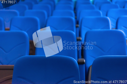 Image of hall with rows of blue seats