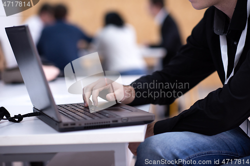 Image of business people hands using laptop computer