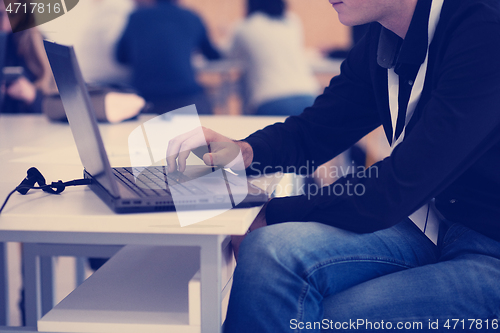 Image of businessman working using a laptop in startup office