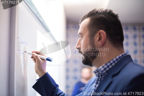 Image of businessman giving presentations at conference room