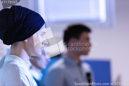 Image of Muslim businesswoman giving presentations at conference room