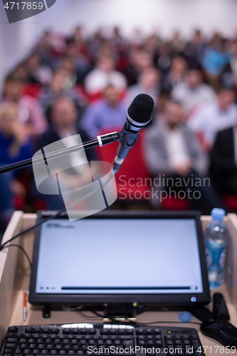 Image of laptop computer and microphone at podium
