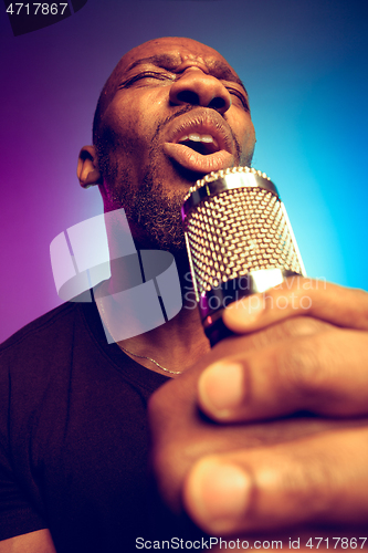 Image of Young african-american jazz musician singing a song