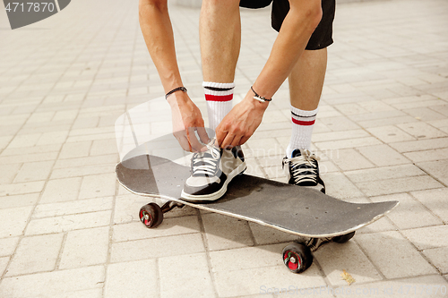 Image of Skateboarder at the city\'s street in cloudly day