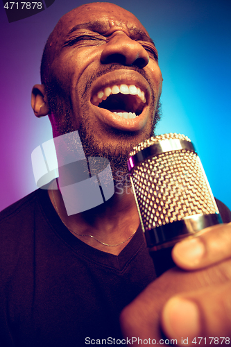 Image of Young african-american jazz musician singing a song