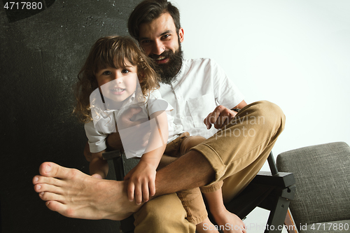 Image of Father playing with young son in their sitting room