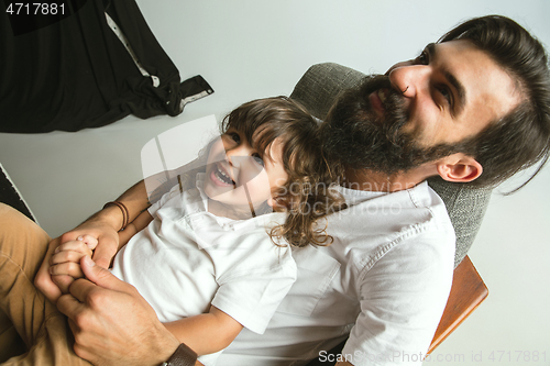 Image of Father playing with young son in their sitting room