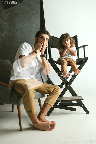 Image of Father playing with young son in their sitting room