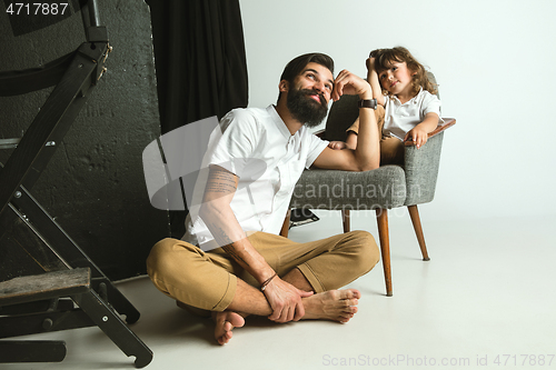 Image of Father playing with young son in their sitting room