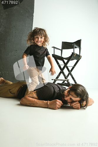 Image of Father playing with young son in their sitting room