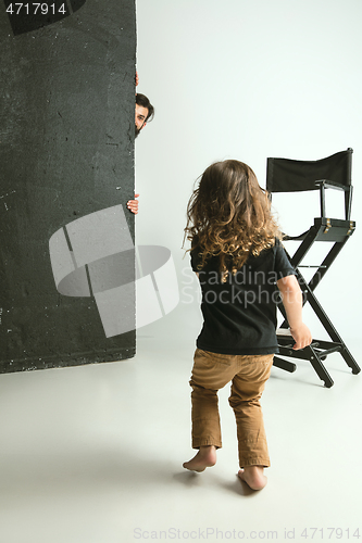Image of Father playing with young son in their sitting room