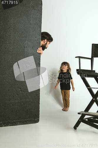 Image of Father playing with young son in their sitting room