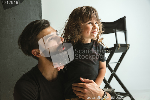 Image of Father playing with young son in their sitting room