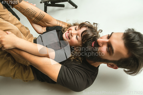 Image of Father playing with young son in their sitting room