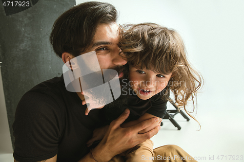 Image of Father playing with young son in their sitting room