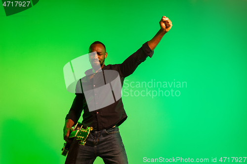 Image of Young african-american jazz musician playing the guitar