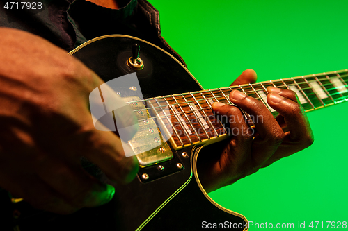 Image of Young african-american jazz musician playing the guitar