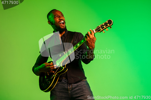 Image of Young african-american jazz musician playing the guitar