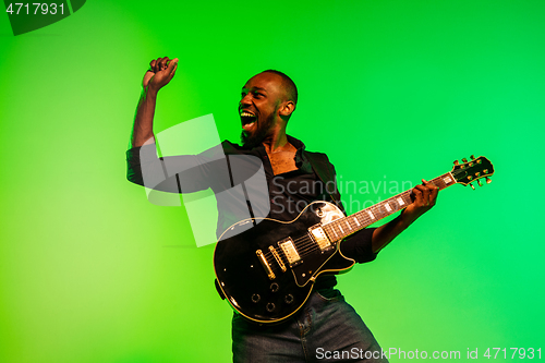 Image of Young african-american jazz musician playing the guitar