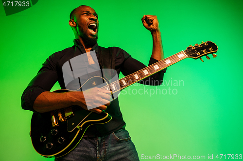 Image of Young african-american jazz musician playing the guitar