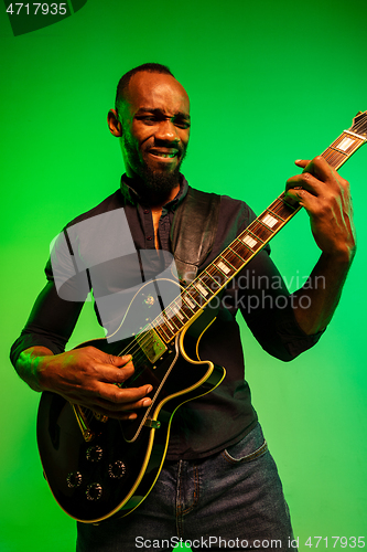 Image of Young african-american jazz musician playing the guitar