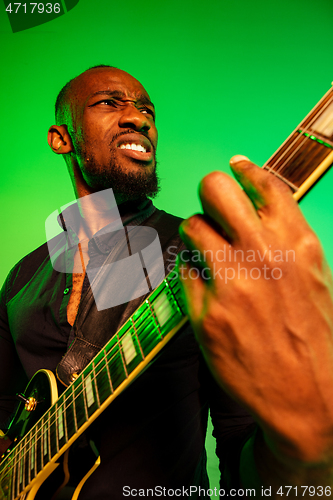 Image of Young african-american jazz musician playing the guitar