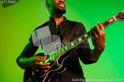 Image of Young african-american jazz musician playing the guitar