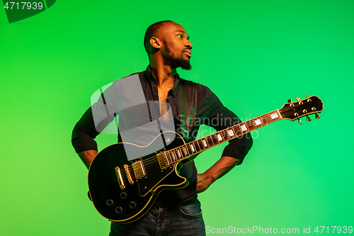 Image of Young african-american jazz musician playing the guitar