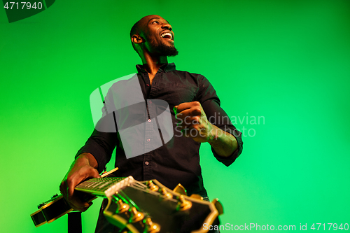 Image of Young african-american jazz musician playing the guitar