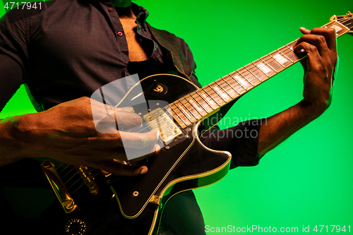Image of Young african-american jazz musician playing the guitar