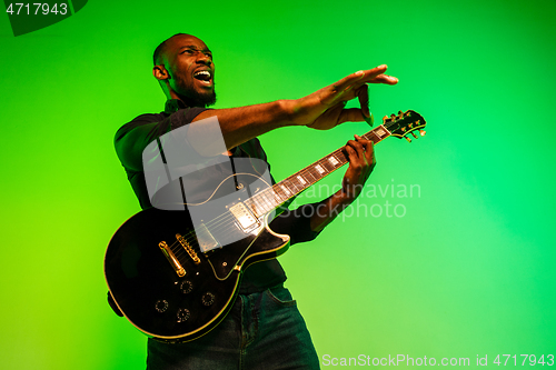 Image of Young african-american jazz musician playing the guitar